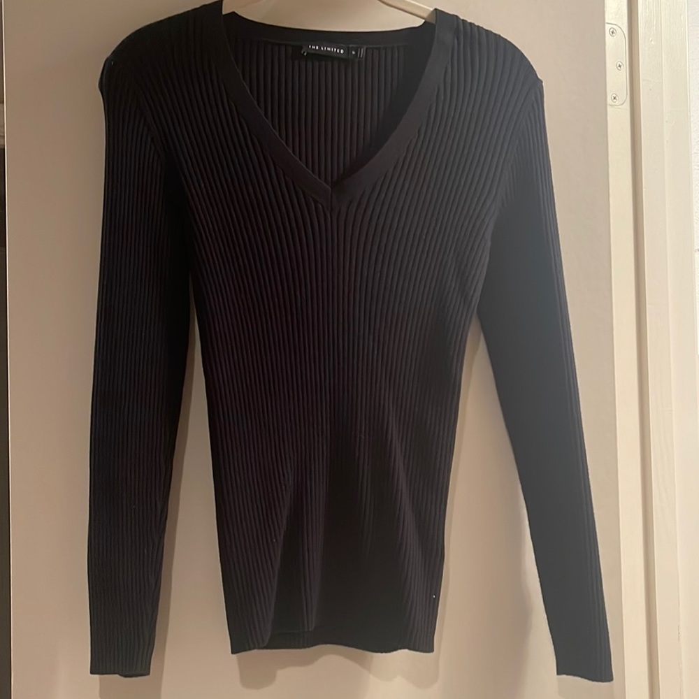 Black ribbed V-neck sweater with button details at wrist